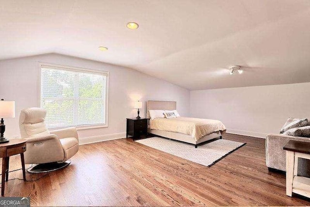 bedroom featuring lofted ceiling and hardwood / wood-style floors