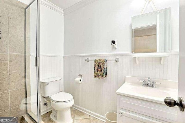 bathroom with toilet, ornamental molding, an enclosed shower, and vanity