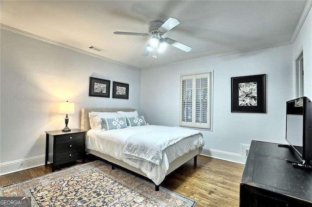 bedroom featuring ceiling fan, wood-type flooring, and crown molding