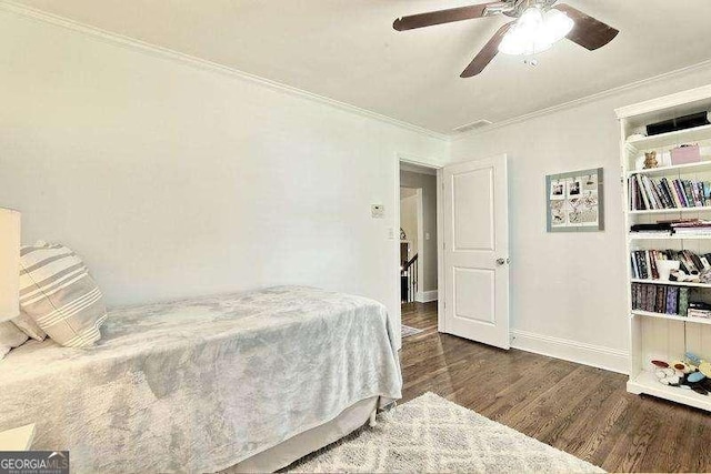 bedroom with ceiling fan, dark hardwood / wood-style flooring, and crown molding