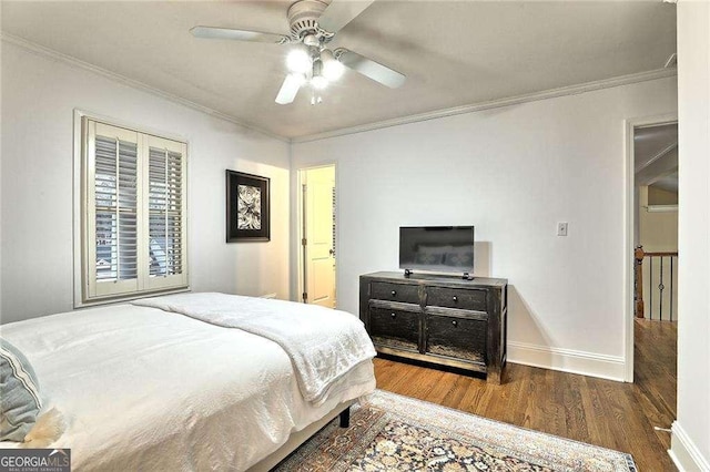 bedroom with ceiling fan, crown molding, baseboards, and wood finished floors