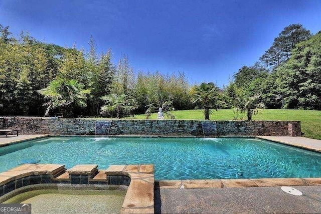 view of pool featuring pool water feature and a lawn