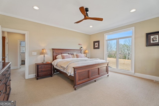 carpeted bedroom featuring ceiling fan and ornamental molding