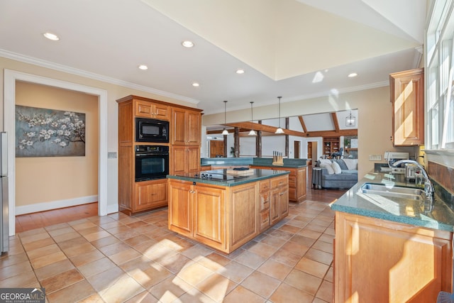 kitchen with kitchen peninsula, black appliances, a kitchen island, pendant lighting, and sink