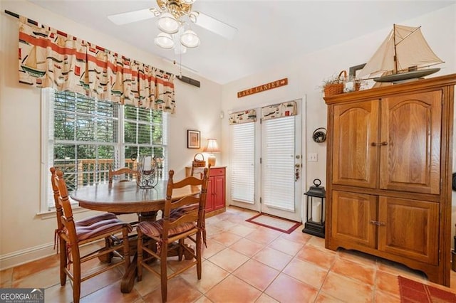 dining space featuring ceiling fan and light tile patterned floors