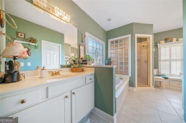 bathroom featuring separate shower and tub, vanity, and tile patterned floors