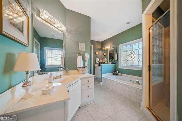 bathroom with tile patterned flooring, shower with separate bathtub, and vanity