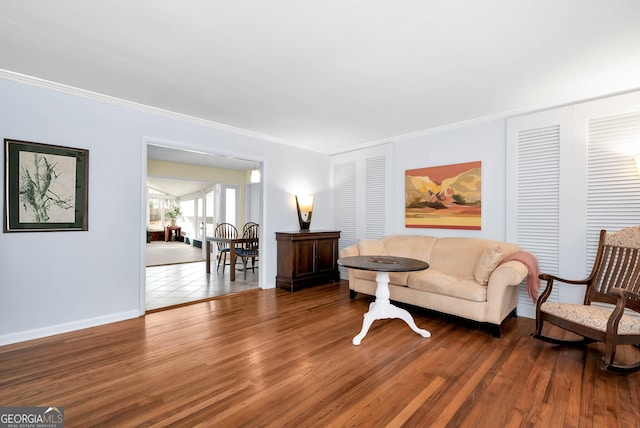 living room with dark hardwood / wood-style floors and crown molding