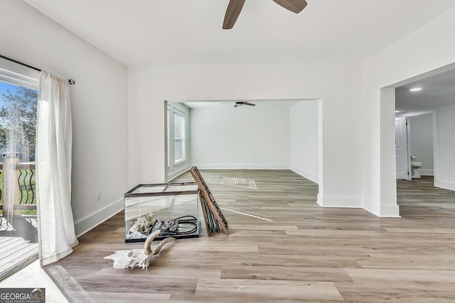 empty room featuring ceiling fan and light hardwood / wood-style floors