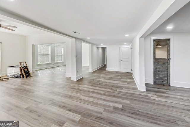 unfurnished living room with ceiling fan and light wood-type flooring