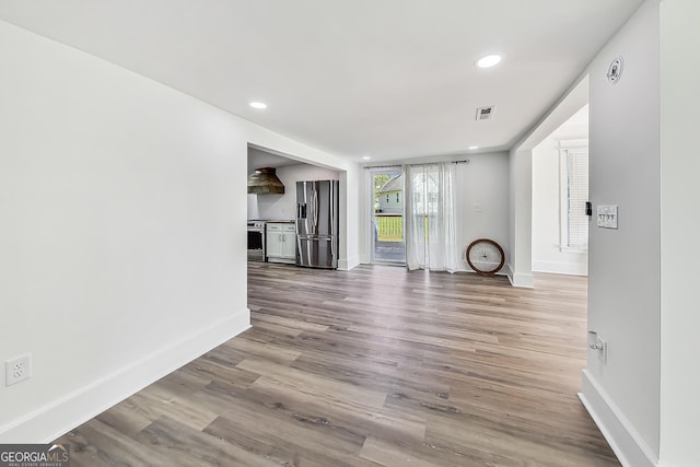 unfurnished living room with wood-type flooring