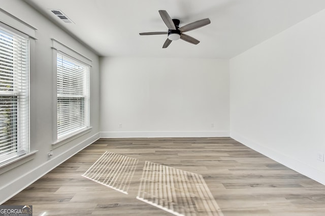 spare room featuring ceiling fan and light hardwood / wood-style flooring