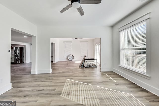 interior space with ceiling fan and light hardwood / wood-style floors