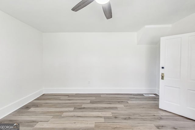 empty room featuring ceiling fan and light hardwood / wood-style floors