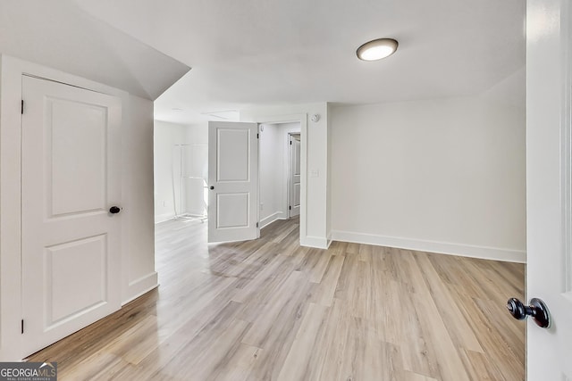 additional living space featuring light wood-type flooring