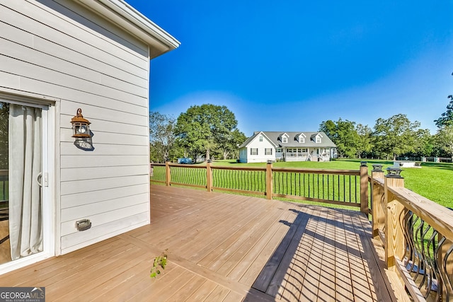 wooden terrace with a yard