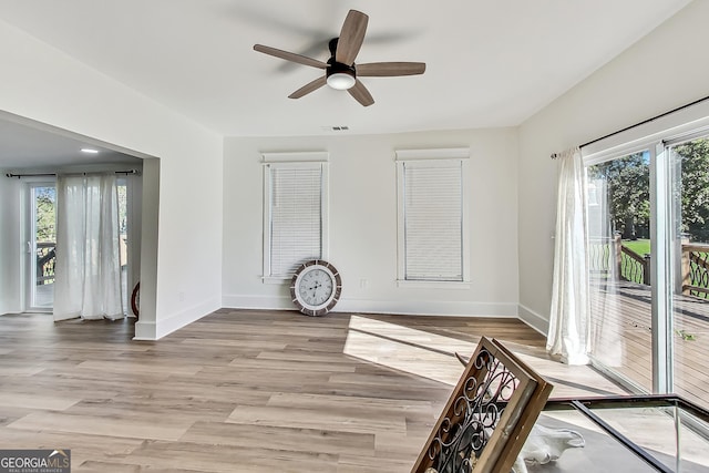 interior space with light wood-type flooring and ceiling fan