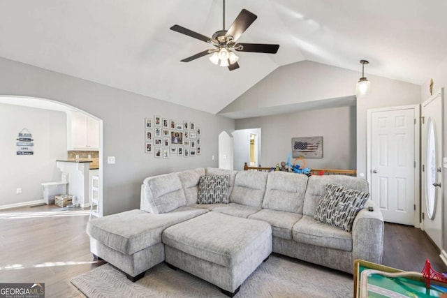 living room with vaulted ceiling, ceiling fan, and light hardwood / wood-style floors