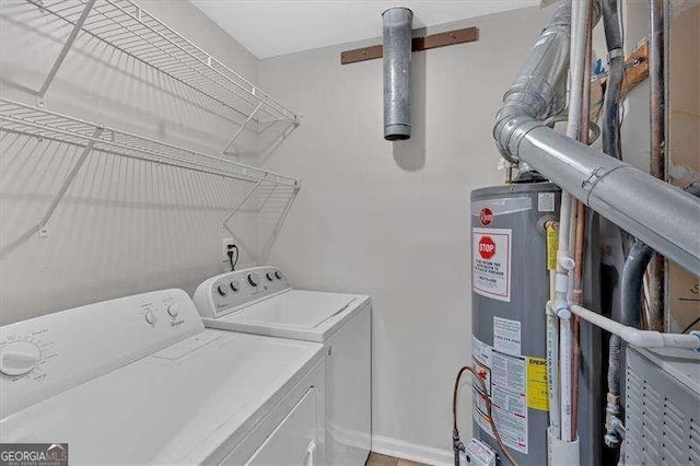 washroom featuring water heater and separate washer and dryer