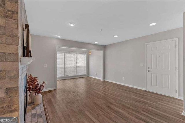 unfurnished living room featuring wood-type flooring