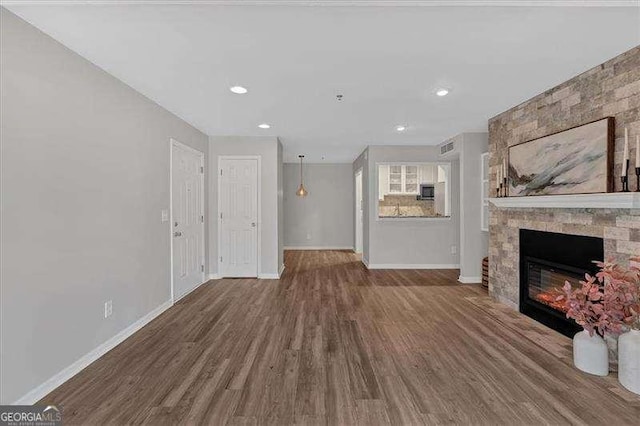 unfurnished living room featuring hardwood / wood-style floors and a fireplace