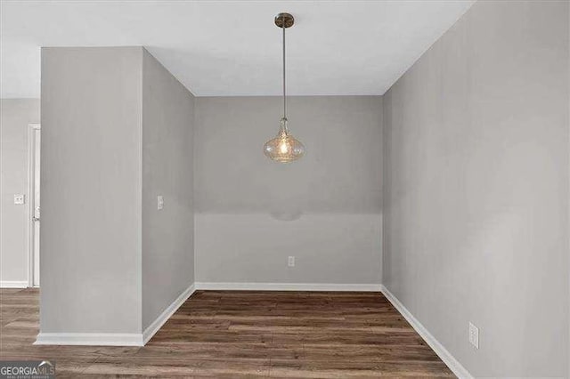 unfurnished dining area featuring dark hardwood / wood-style flooring