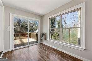 interior space featuring a wealth of natural light and dark hardwood / wood-style flooring