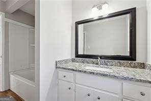 bathroom featuring vanity and washtub / shower combination