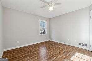 unfurnished room featuring ceiling fan and dark hardwood / wood-style flooring