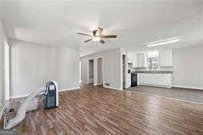 unfurnished living room with dark hardwood / wood-style floors