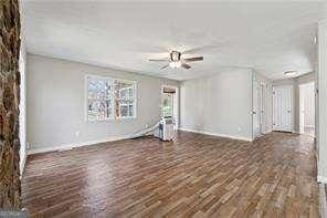 unfurnished room featuring ceiling fan and dark hardwood / wood-style floors