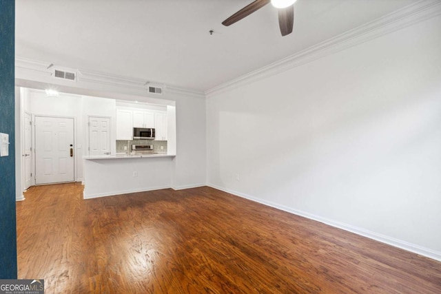 unfurnished living room with ceiling fan, dark hardwood / wood-style floors, and ornamental molding