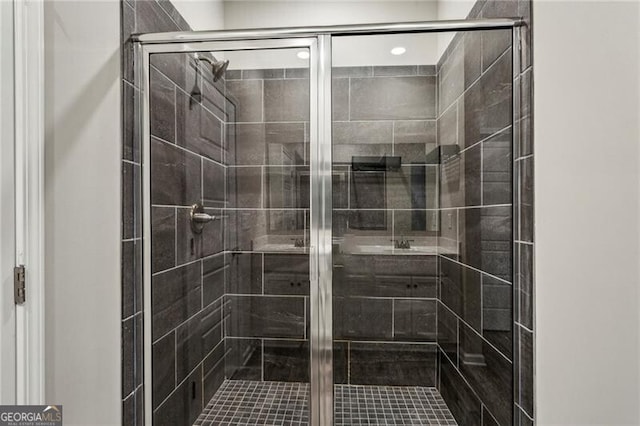 bathroom featuring a shower with door