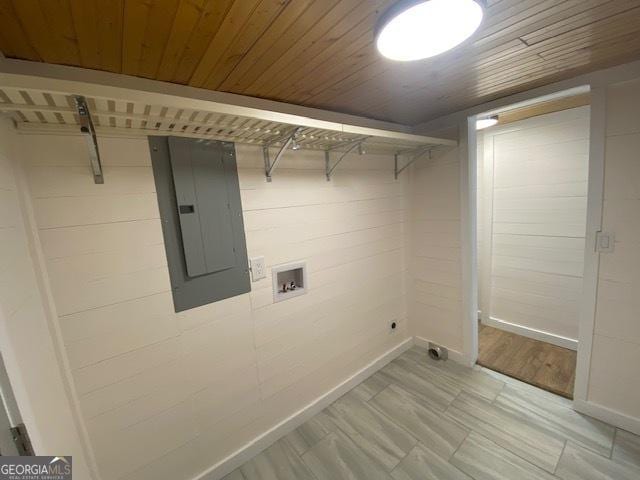 clothes washing area with washer hookup, electric panel, and wood ceiling