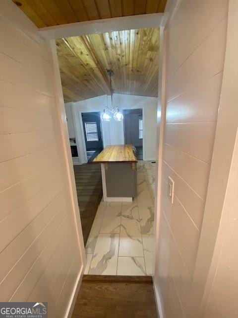 corridor featuring lofted ceiling and wooden ceiling