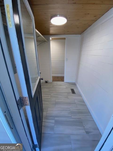 corridor with visible vents and wooden ceiling