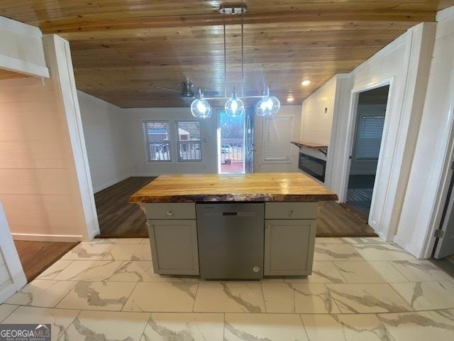 kitchen with a kitchen island, wooden counters, gray cabinetry, and dishwashing machine