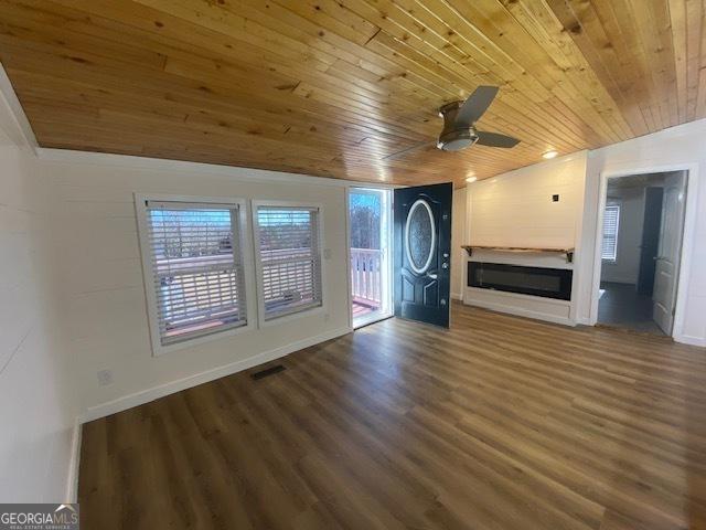 unfurnished living room featuring wood finished floors, visible vents, wooden ceiling, and ceiling fan