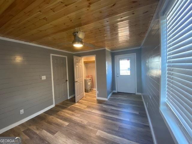 foyer featuring wood-type flooring, ceiling fan, wood ceiling, crown molding, and wood walls