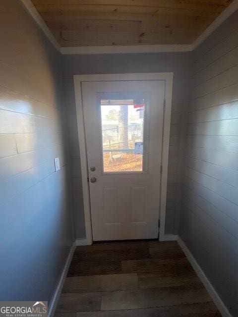 entryway with wood ceiling, wood finished floors, baseboards, and ornamental molding