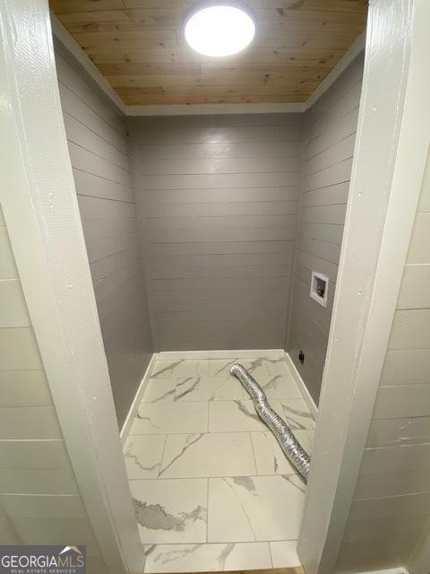 laundry room featuring laundry area, marble finish floor, hookup for a washing machine, and wood ceiling