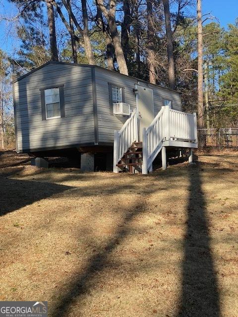 back of property featuring a yard and cooling unit