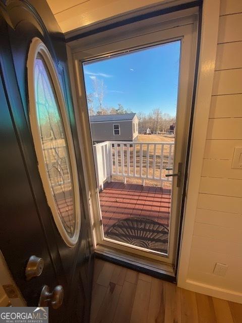 doorway featuring wood finished floors