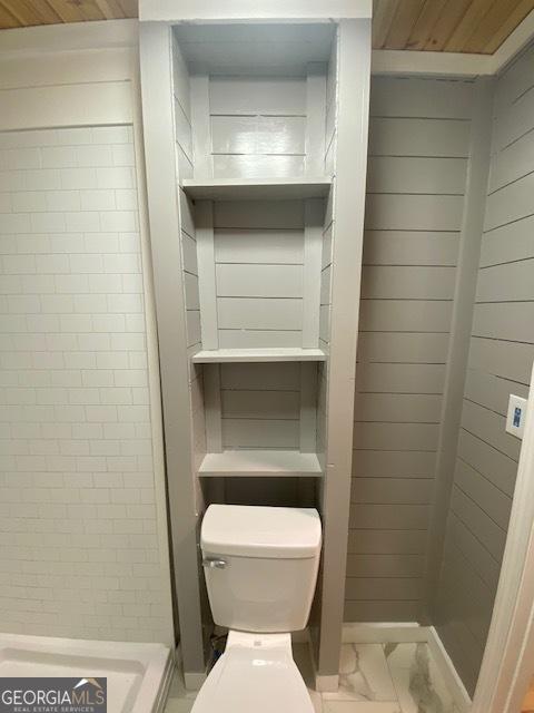 bathroom featuring toilet and marble finish floor