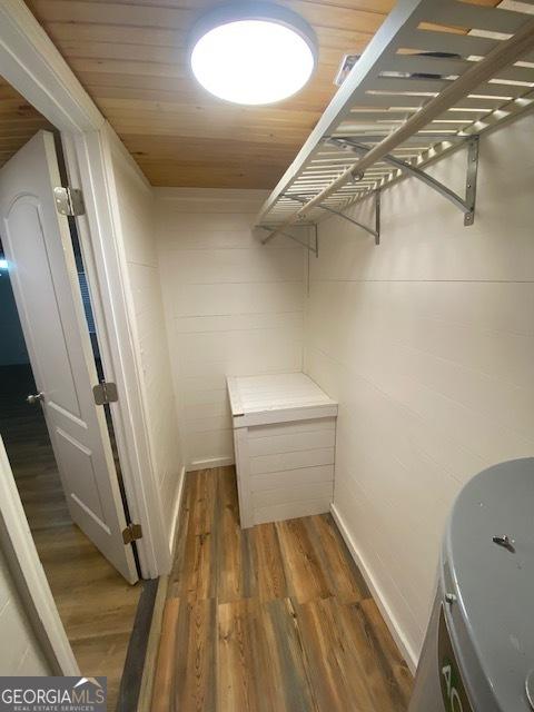 walk in closet featuring dark wood-type flooring