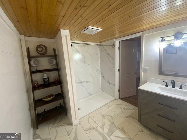 bathroom with a marble finish shower, visible vents, wooden ceiling, and marble finish floor