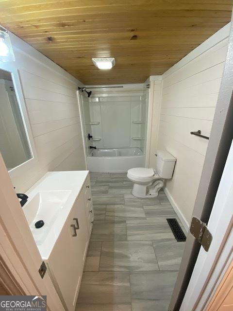 full bathroom with toilet, wooden walls, bathtub / shower combination, wood ceiling, and vanity