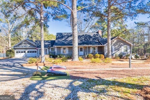 ranch-style home with a porch and a garage