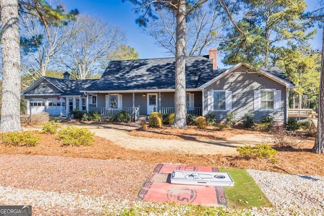 ranch-style home with a garage and a porch