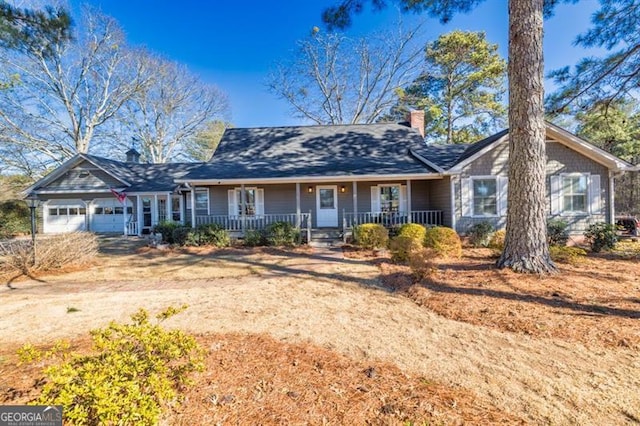 ranch-style house with a garage and a porch